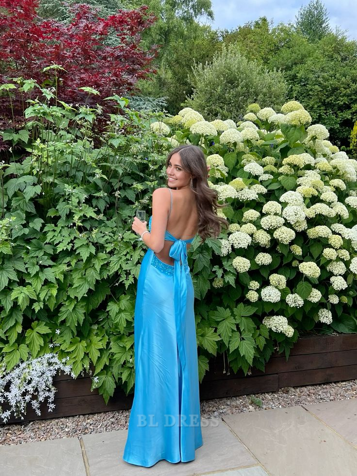 Side view of the elegant blue backless evening gown.