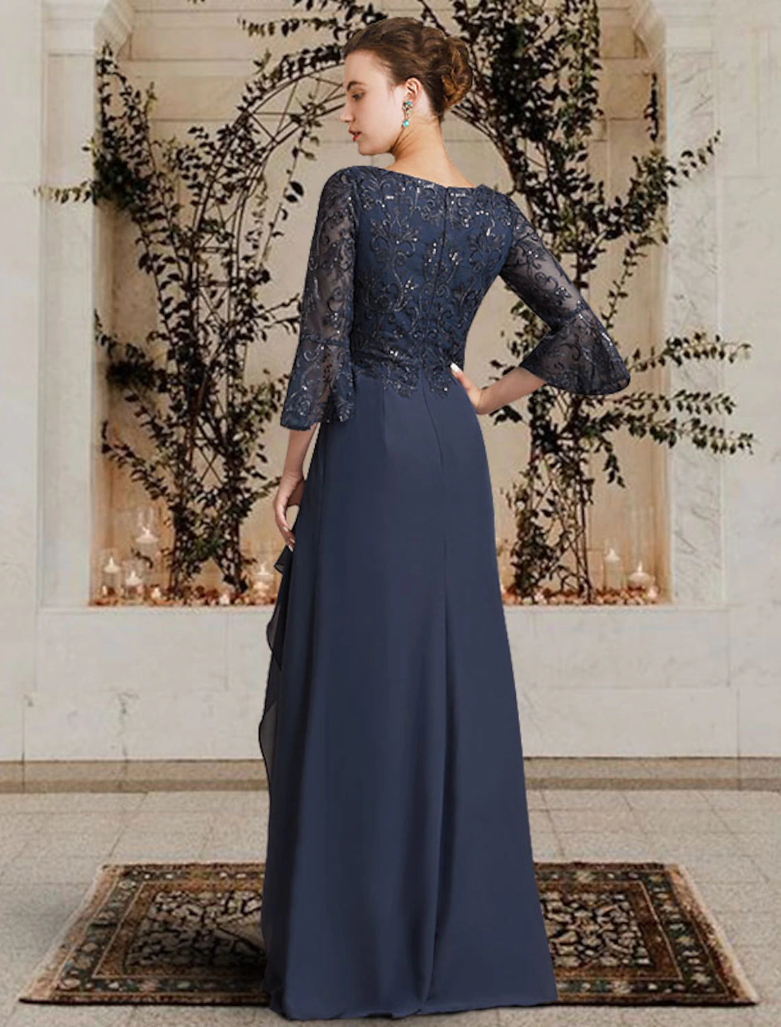 Close-up of chiffon lace, pleats, and appliques on a Mother of the Bride gown.