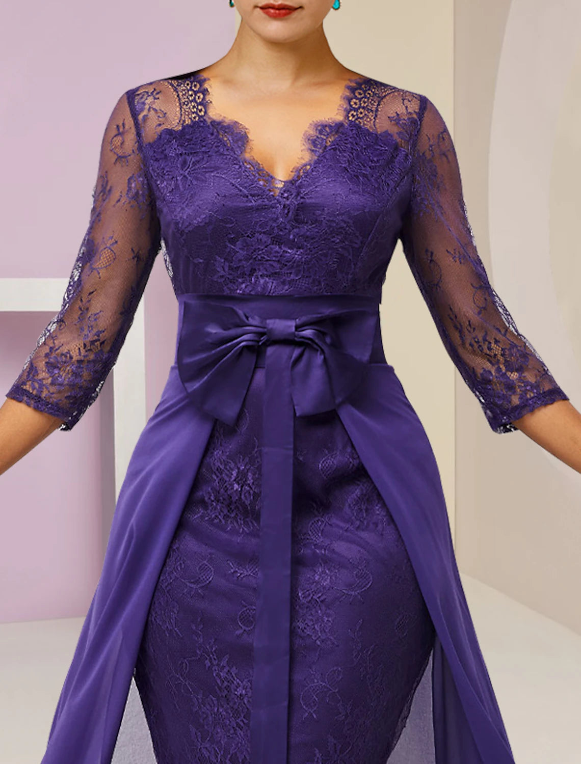 Detail of the lace fabric and bow embellishment on the formal two-piece dress.