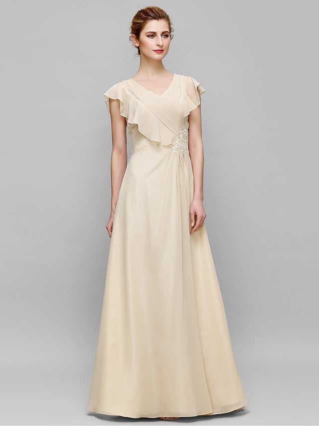 Close-up of the criss-cross appliques on the bodice of the dark blue chiffon dress.