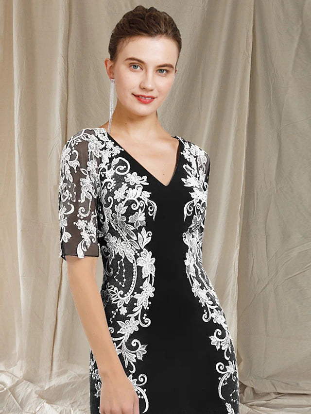 Close-up of the lace and applique embellishments on the half-sleeve dress.