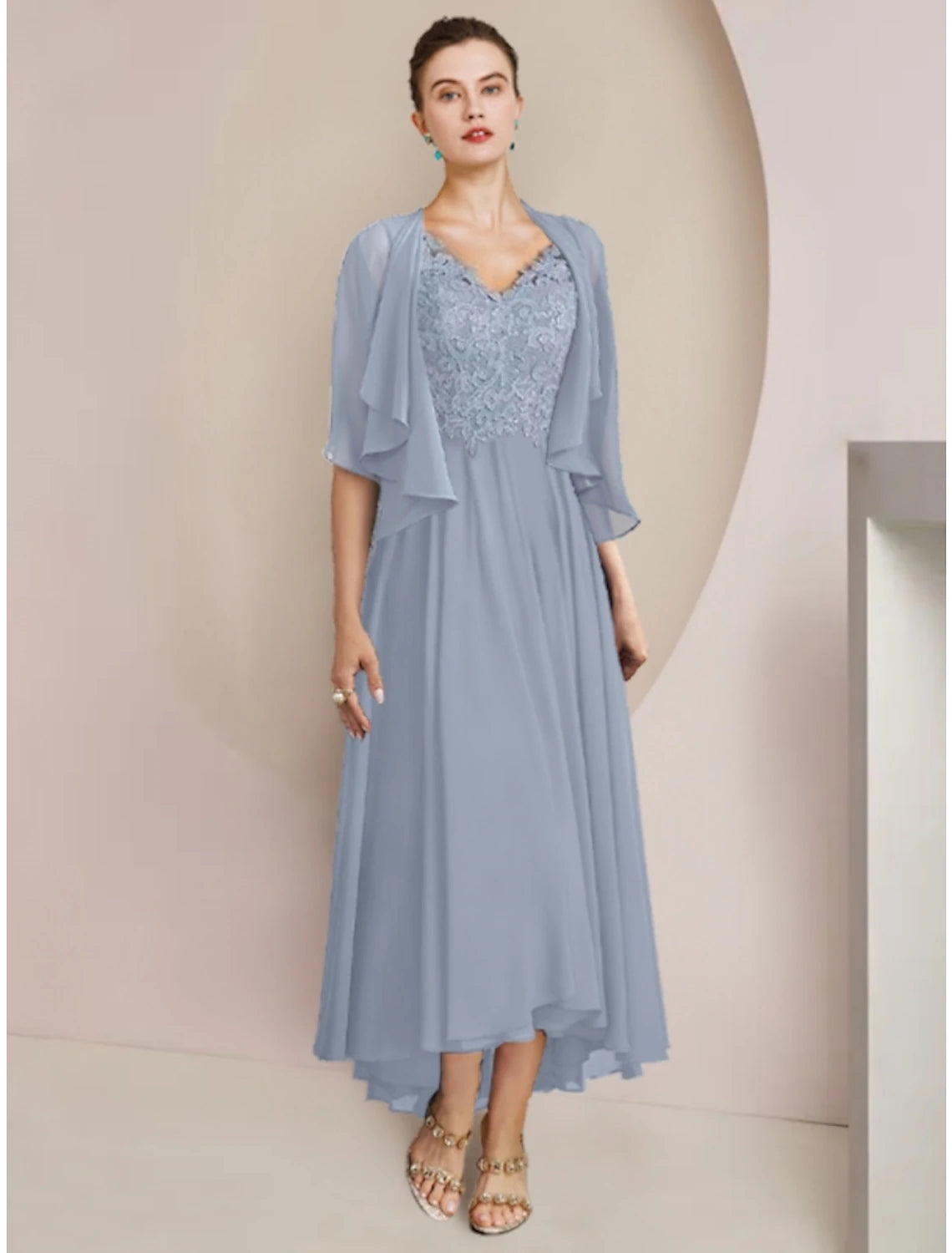 A woman wearing an elegant solid color sheath column dress with a V-neck, half sleeves, and an asymmetrical ankle-length hem.