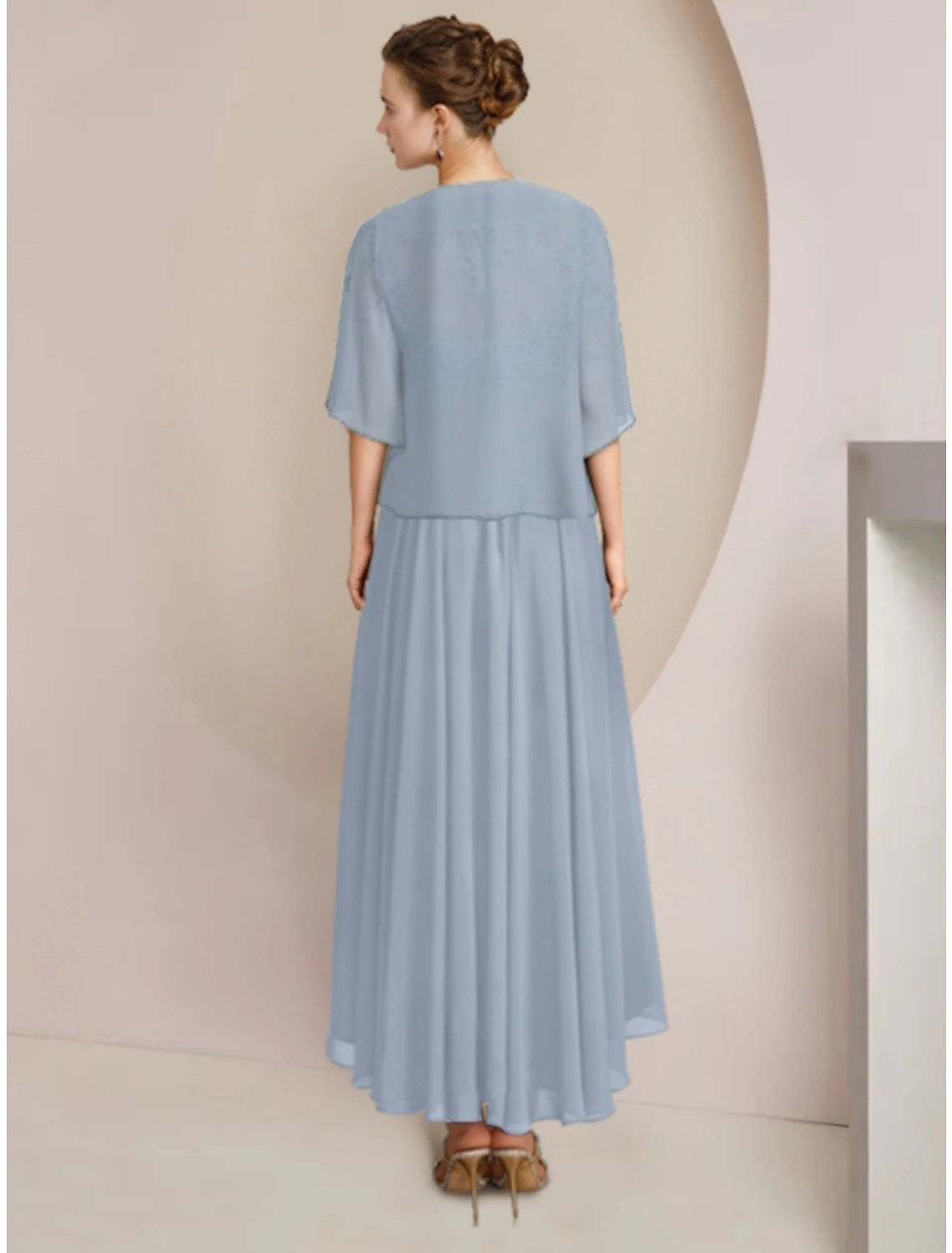 Side view of the elegant sheath column dress, highlighting the half sleeves and pleated details.