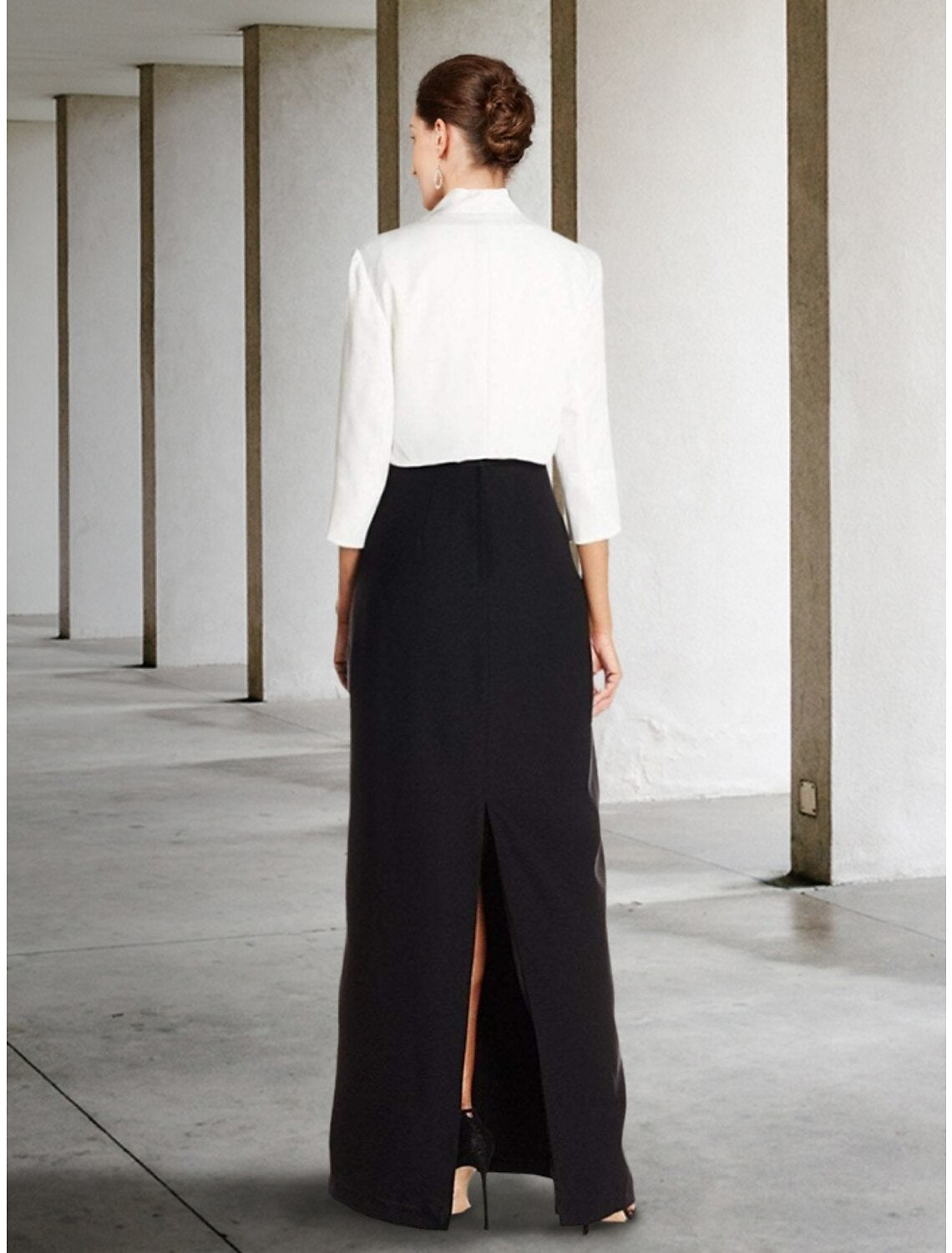 Side view of the black two-piece sheath dress, showing ruching and ankle length.
