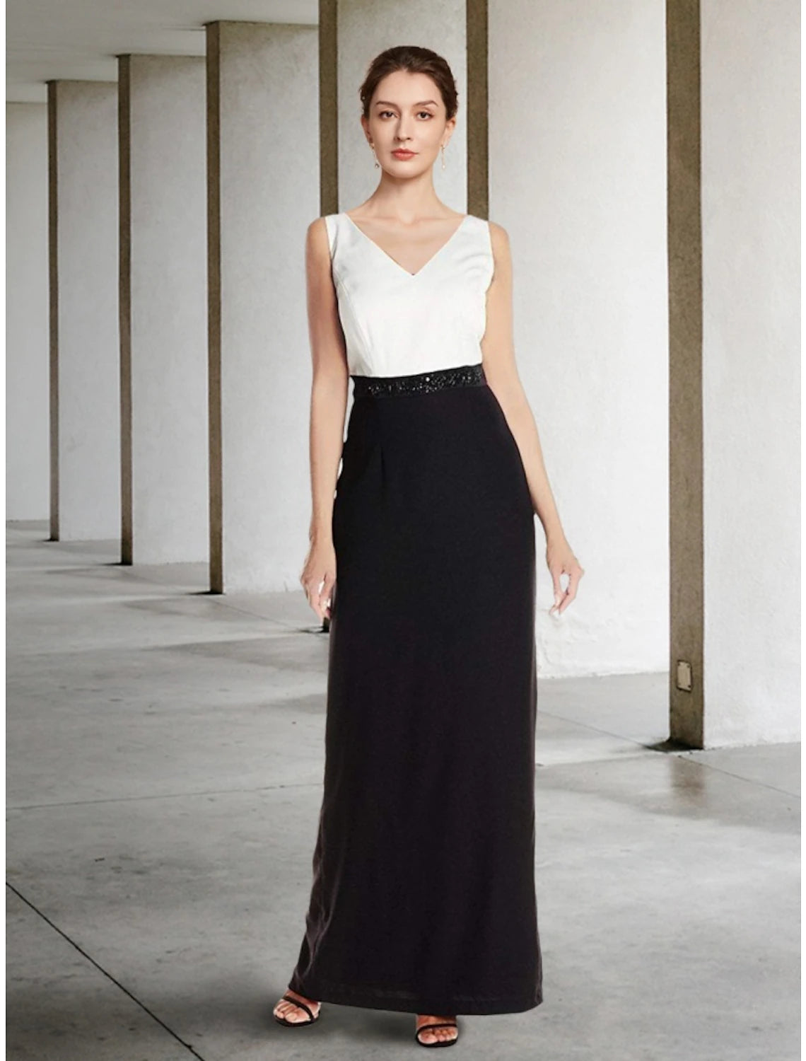 Back view of the elegant black two-piece dress, highlighting the column silhouette.