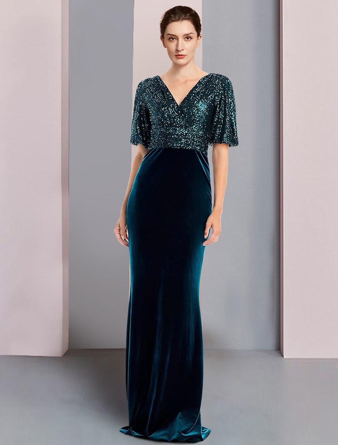 Elegant sequined velvet color block sheath gown with V-neck and half sleeves.