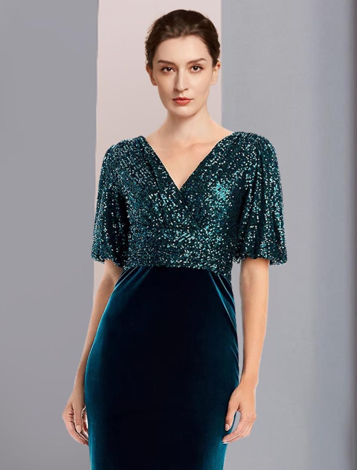 Back view of the elegant sequined velvet sheath gown with sweep train.