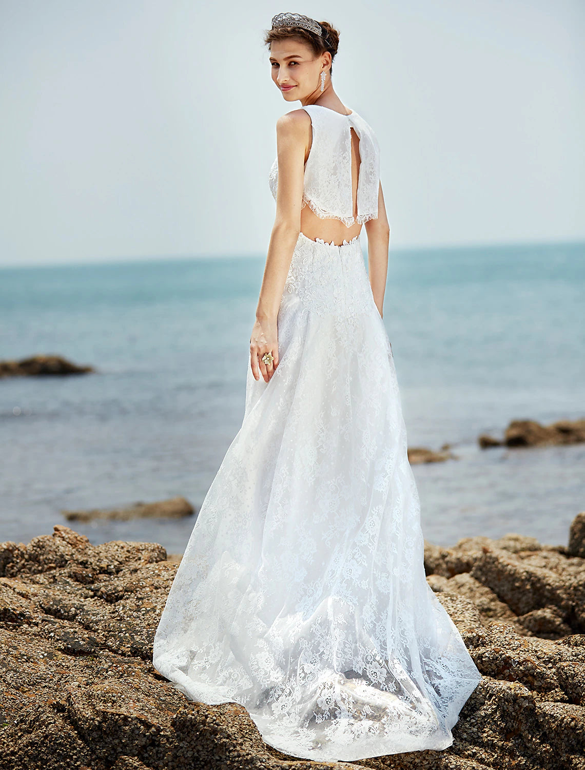 Back view of a wedding dress showing button details and lace appliques.