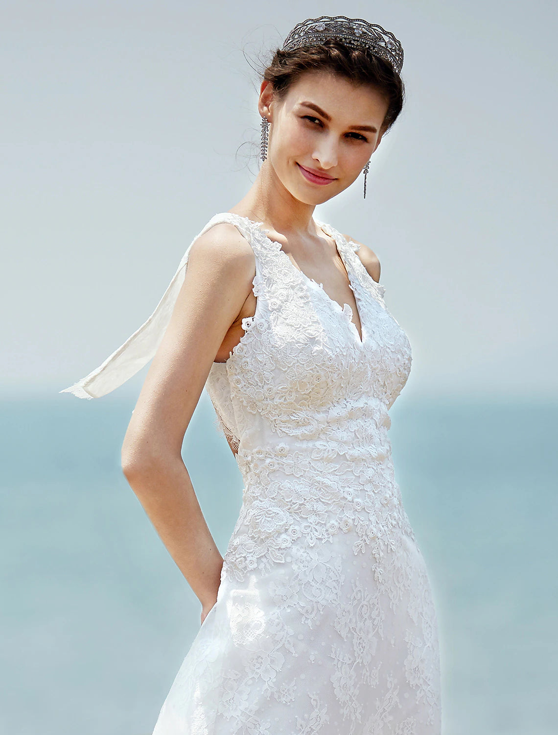 Full length view of a sleeveless V-neck bridal gown.