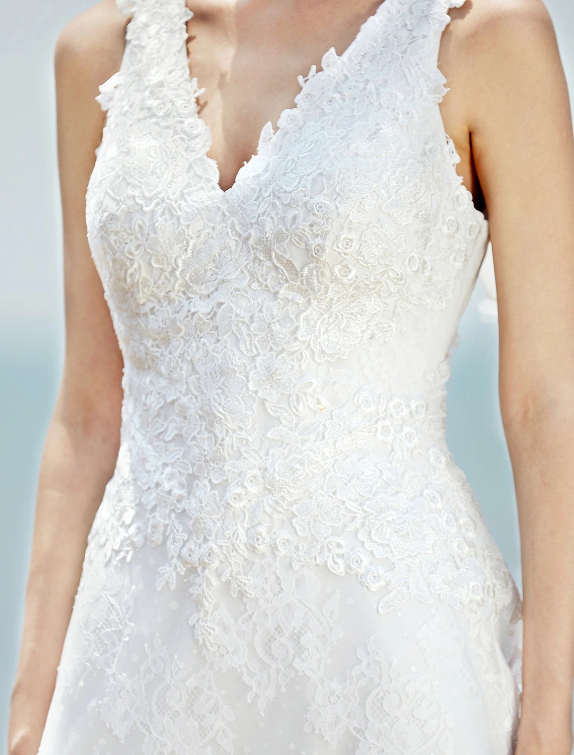 Detail of the V-neckline and lace on a bridal gown.