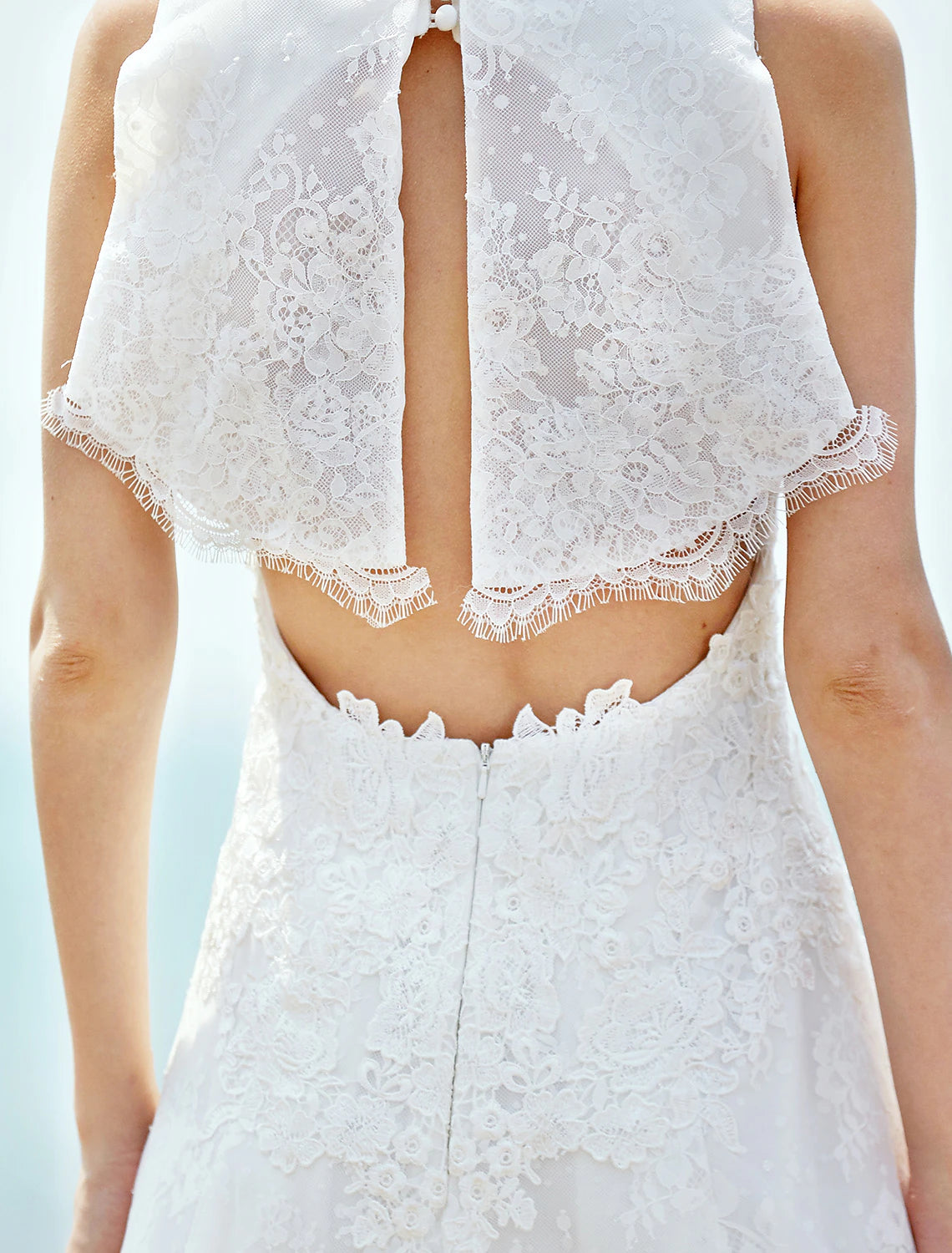 Wedding dress with a sleek sheath silhouette and elegant button accents.