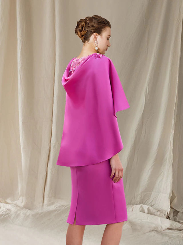 Close-up of the V-neckline and lace beading on the elegant sheath dress.