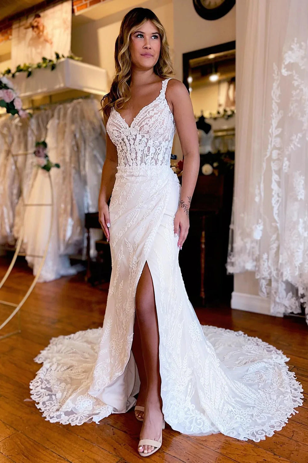 Elegant white sheath lace wedding dress with V-neck and front slit.