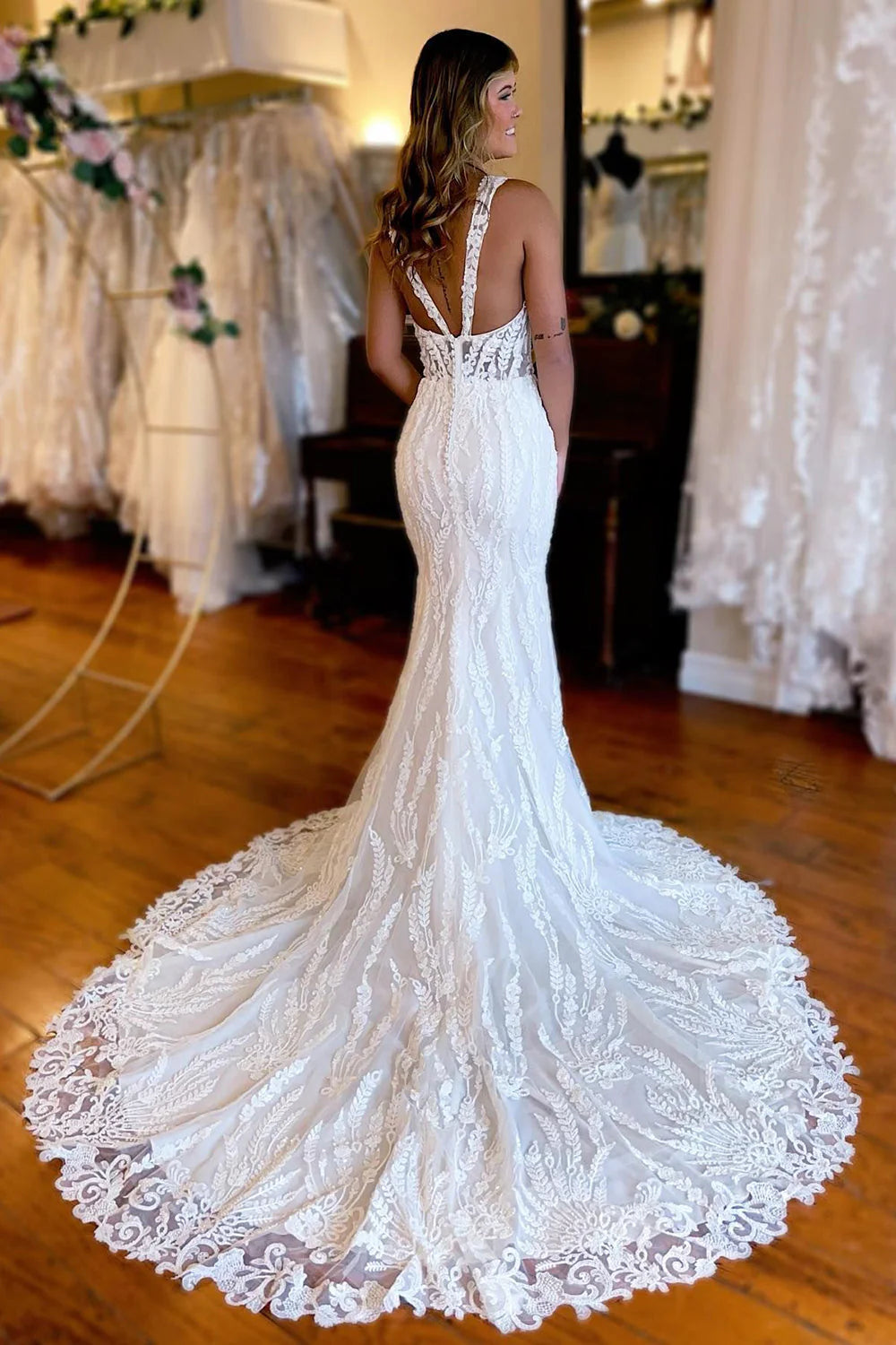 Side view of the long white lace bridal gown.