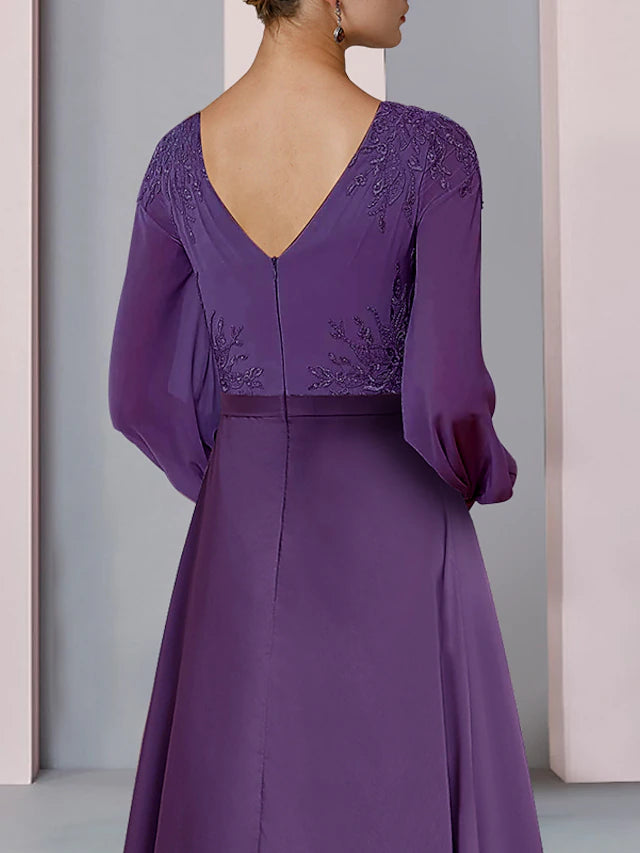 Back view of elegant long sleeve wedding guest gown.