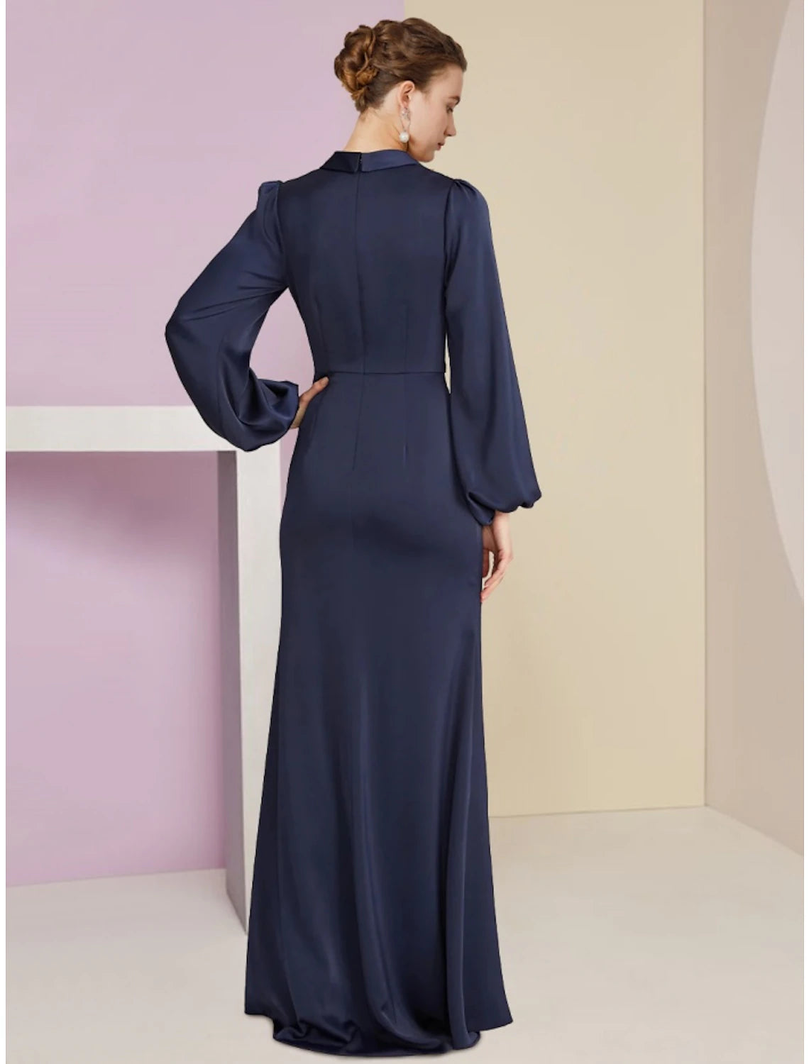 Back view of a floor-length stretch satin V-neck dress with long sleeves.