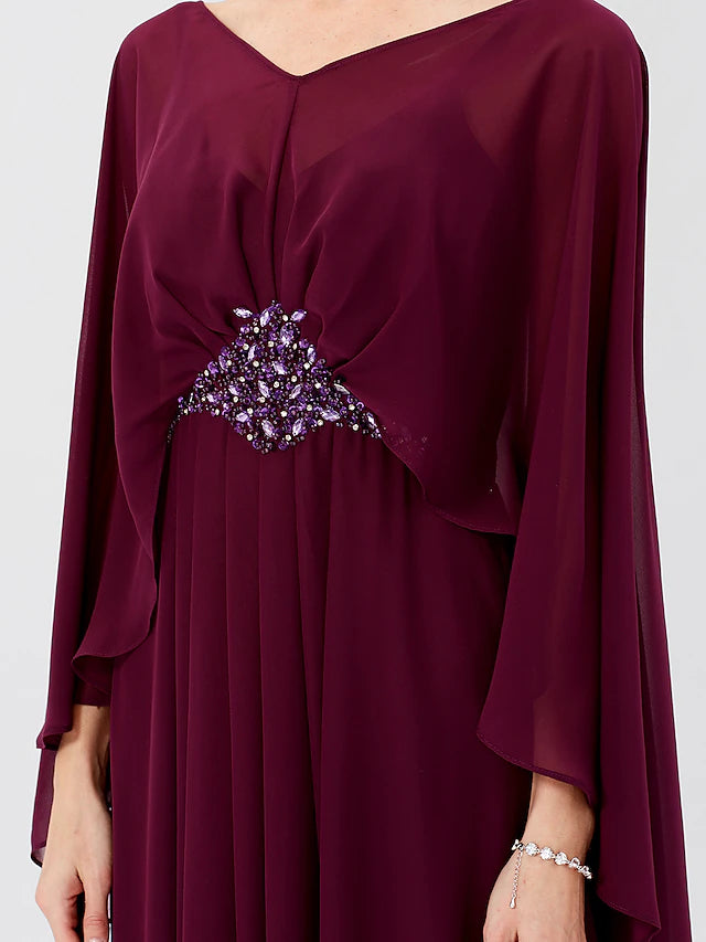 Close-up of the beaded and pleated details on the chiffon dress.