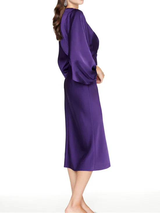 Close-up of the V-neckline and fitted bodice of the sheath dress.