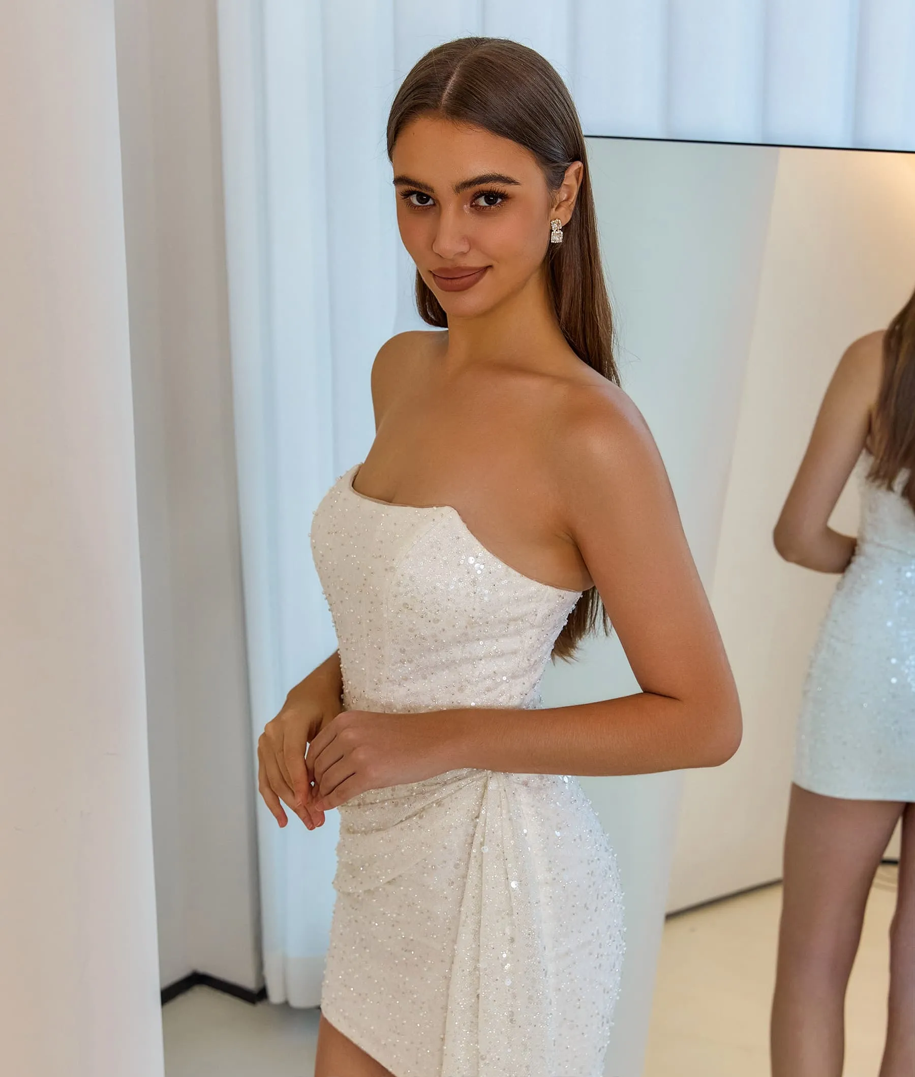 Side view of a short corset-style party dress.