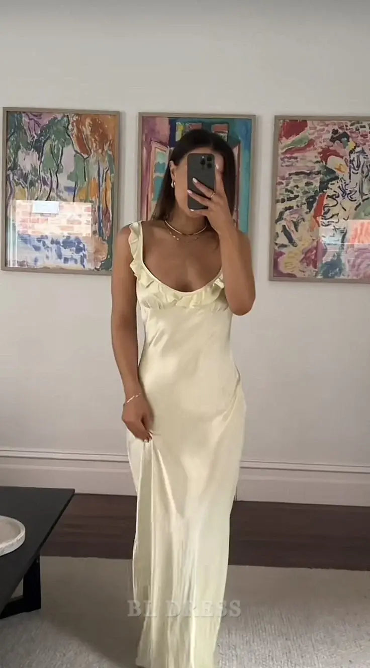 Light yellow satin sheath dress with V-neck and ruffle detail.