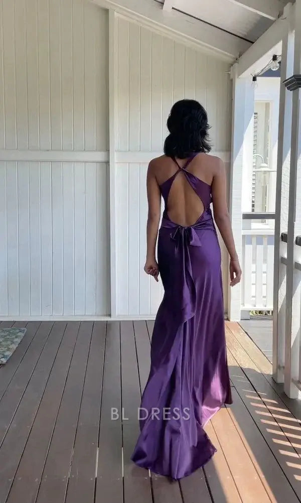 Full view of a woman in a sophisticated V-neck satin formal gown.