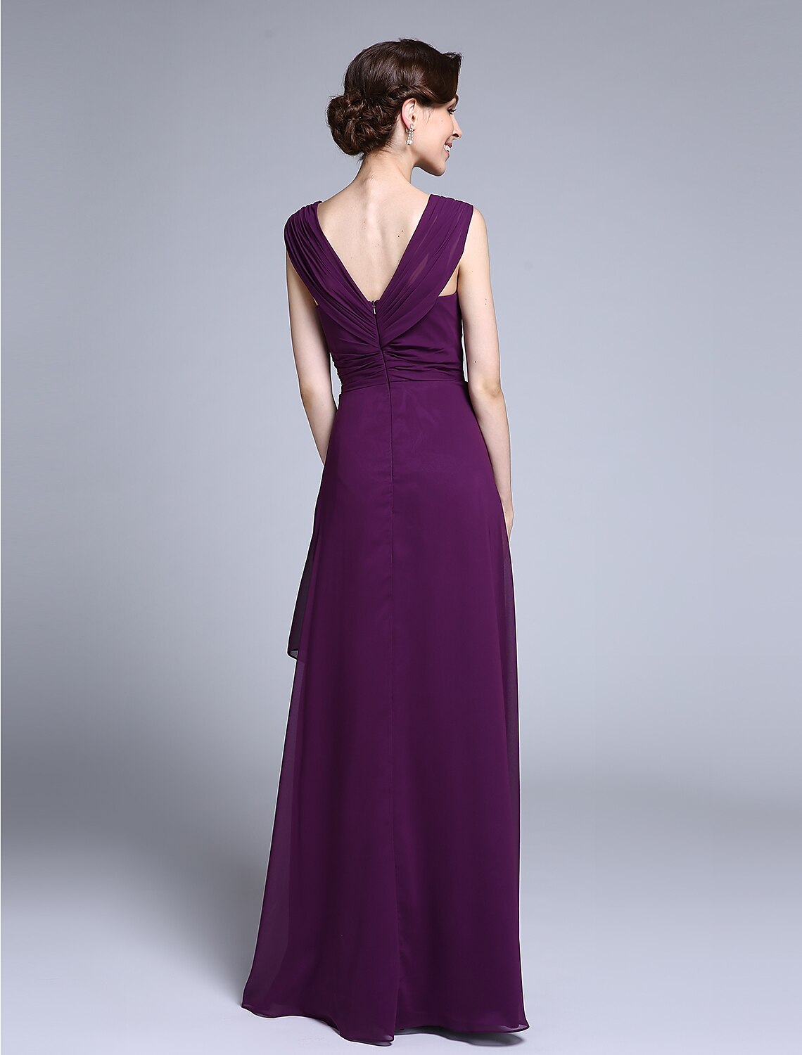 Side view of a woman in a navy blue floor-length Mother of the Bride dress.