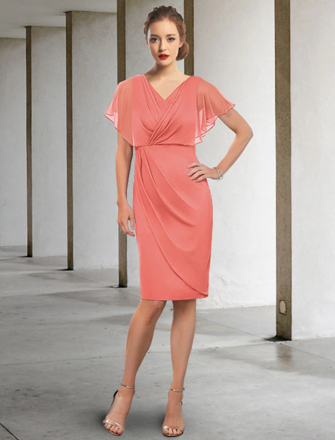 Woman wearing an elegant V-neck short sleeve ruched chiffon knee-length Mother of the Bride dress.