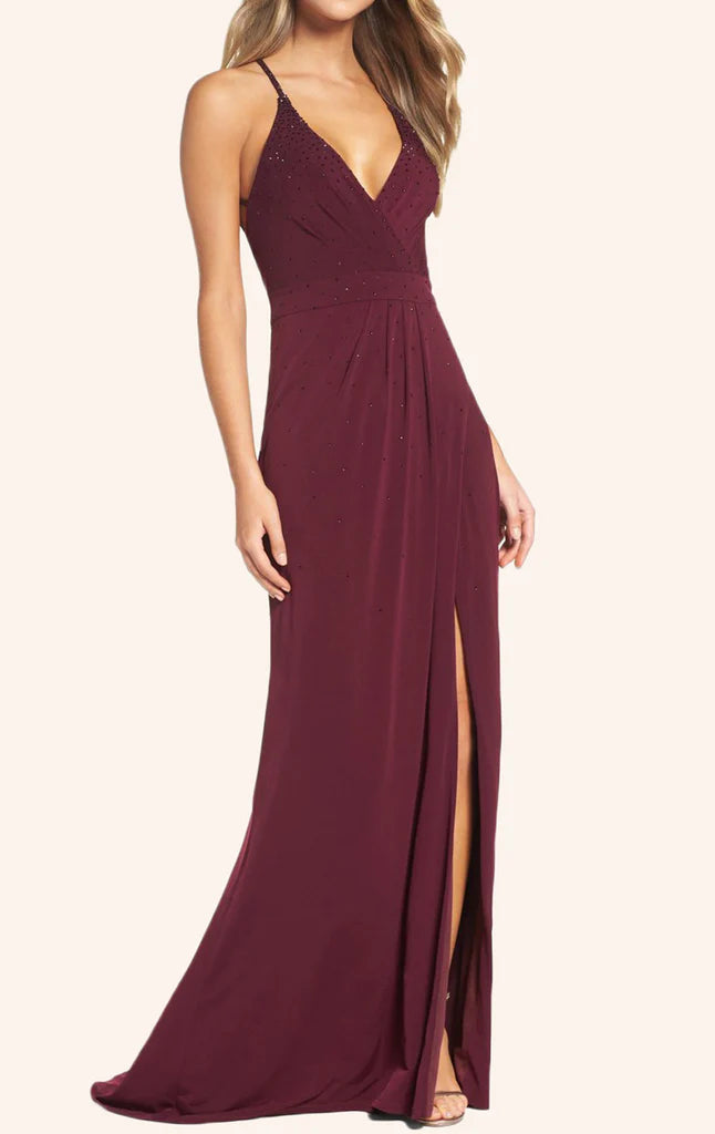 Woman wearing an elegant V-neck sheath prom dress with spaghetti straps.