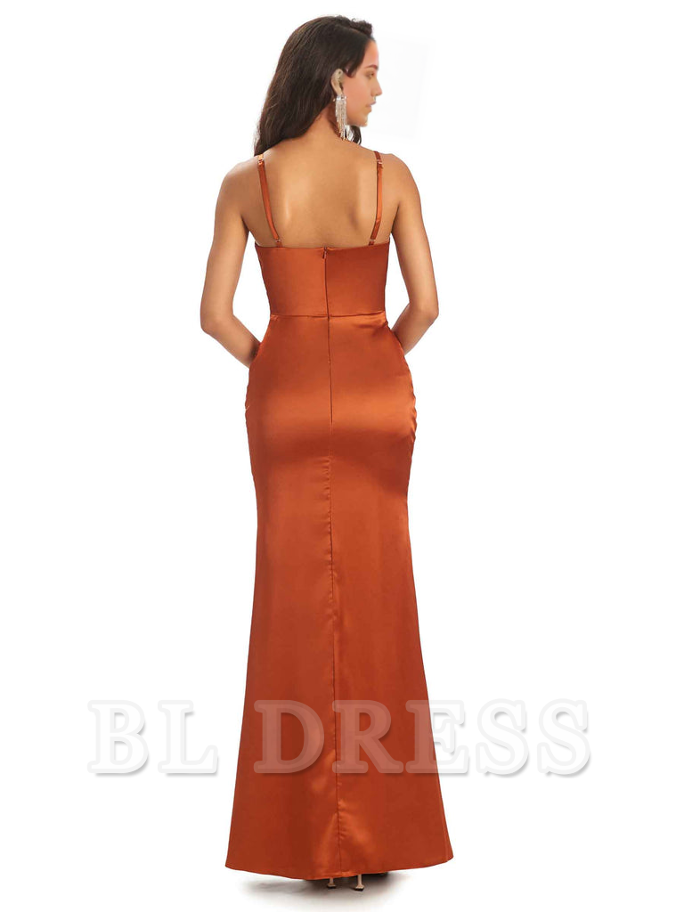 Back view of a woman in a flowing satin sheath dress, highlighting the elegant drape.