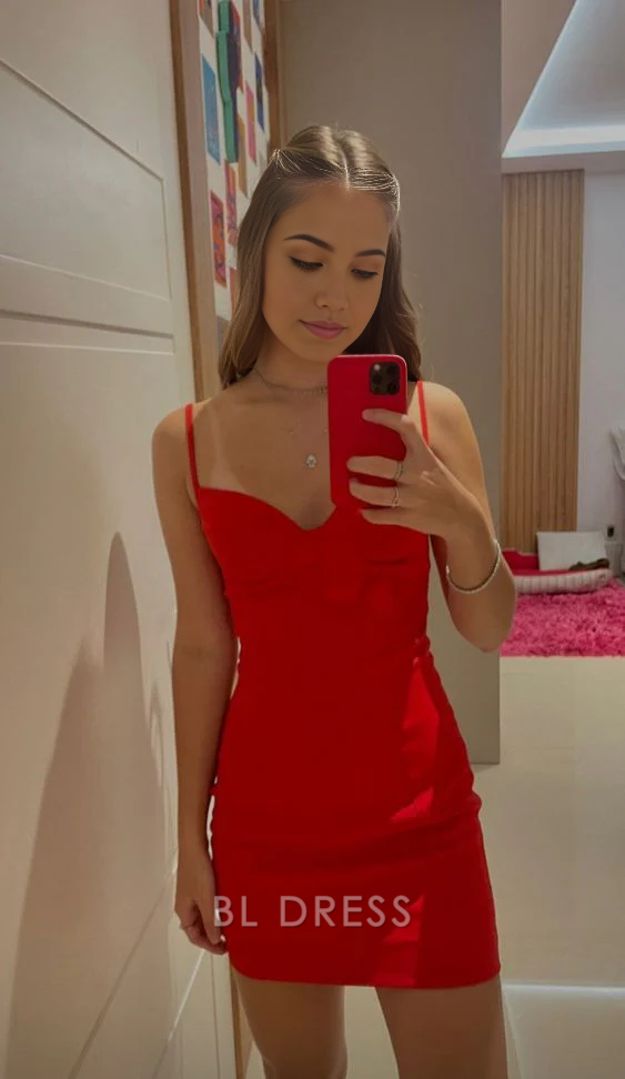 Woman wearing a red sheath bodycon mini dress with spaghetti straps.