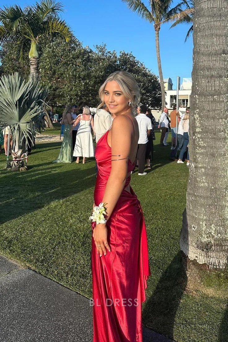 Side view of a red satin sheath maxi dress, highlighting the long slit detail.