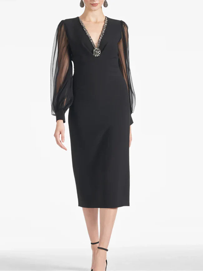 Woman wearing a sleeveless V-neck tea-length sheath dress.
