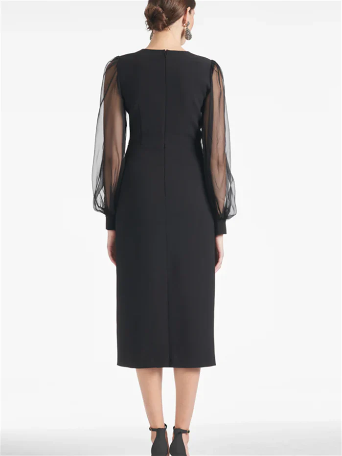 Side view of the sleeveless V-neck tea-length sheath dress.