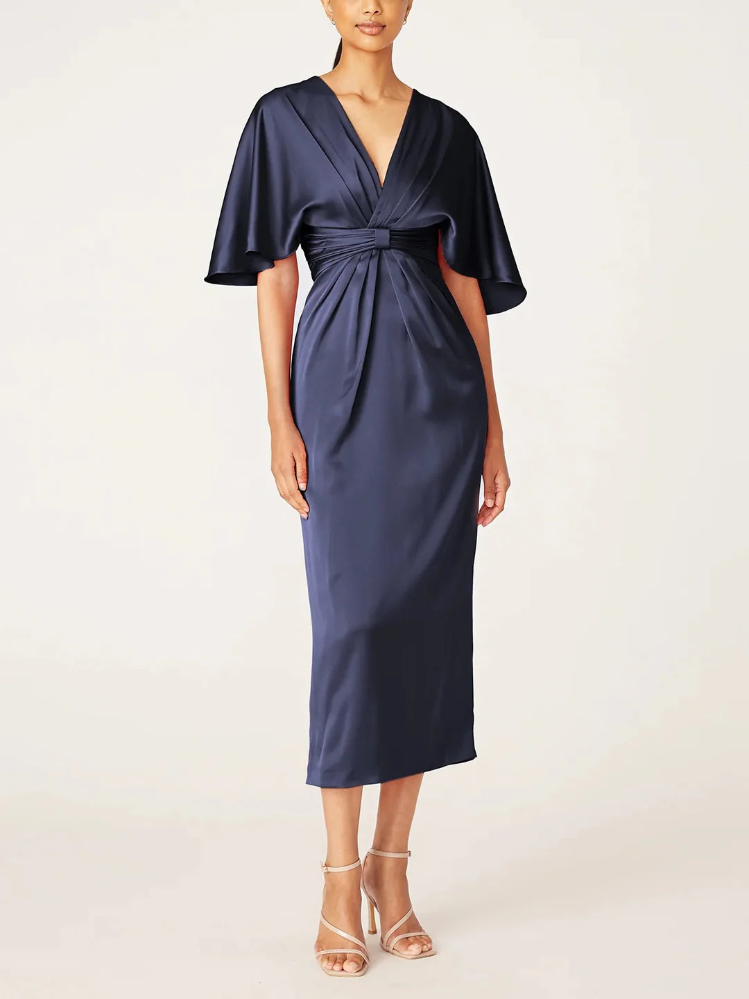 Elegant woman wearing a V-neck tea length sheath Mother of the Bride dress.