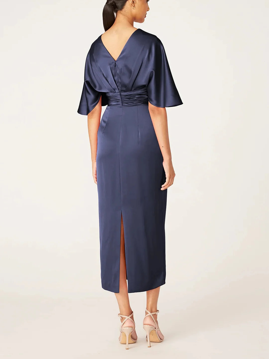 Back view of the elegant tea length sheath dress with sleeves.