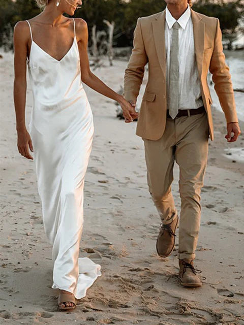 Sheath wedding dress with spaghetti straps and V-neck.