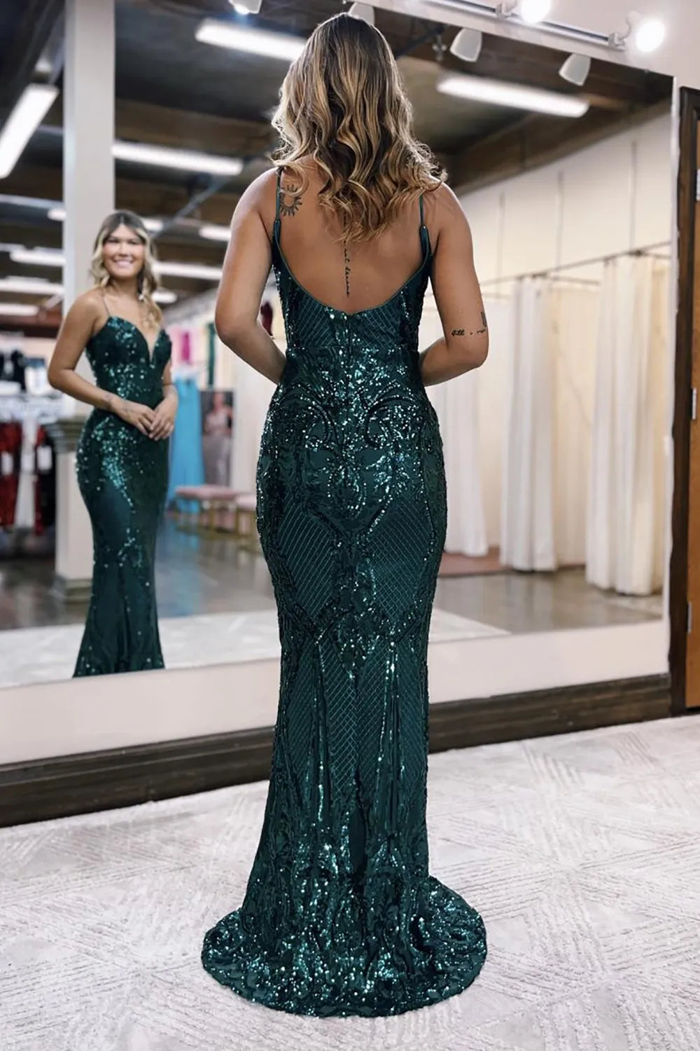 Back view of a woman in a long glitter mermaid gown.