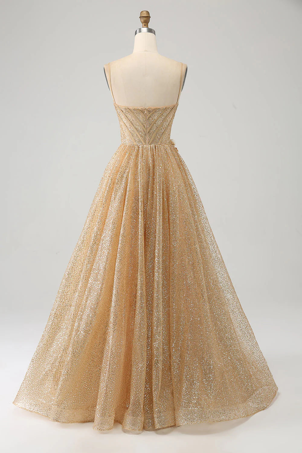 Close-up of the back of the golden glitter prom dress, showing the lace-up corset detail.