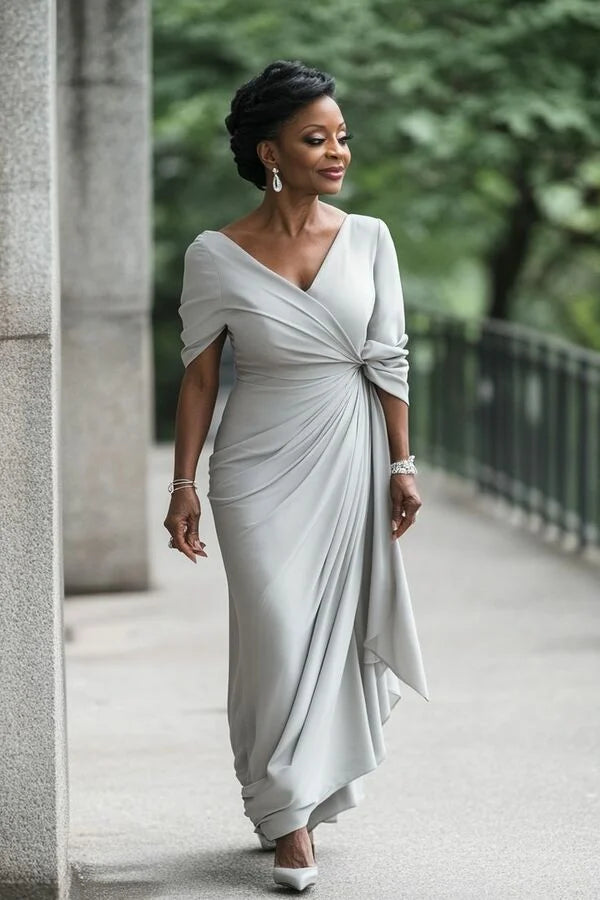 Elegant silver sheath dress with V-neck and ruched details.