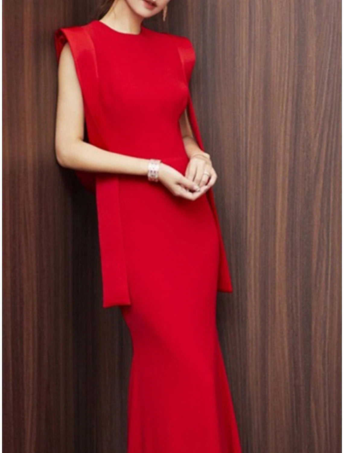 Back view of the red sleeveless mermaid gown, highlighting the fitted silhouette.