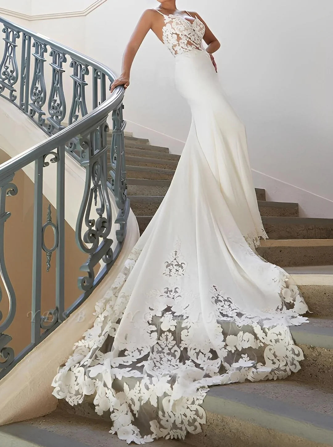Elegant sleeveless mermaid V-neck lace wedding dress on a model.