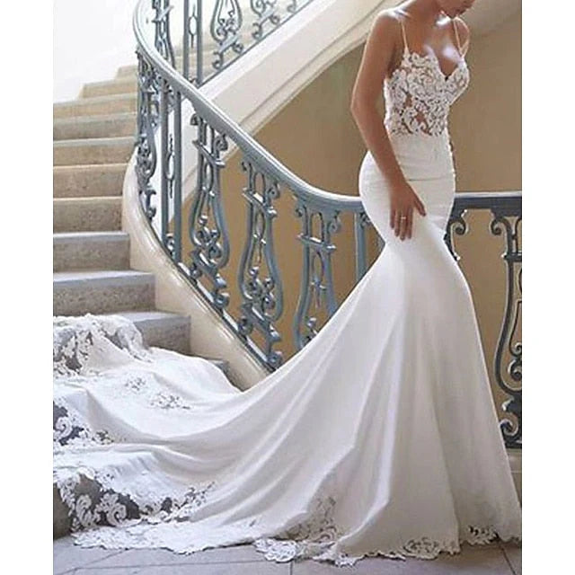 Close-up of delicate lace details on a wedding dress.