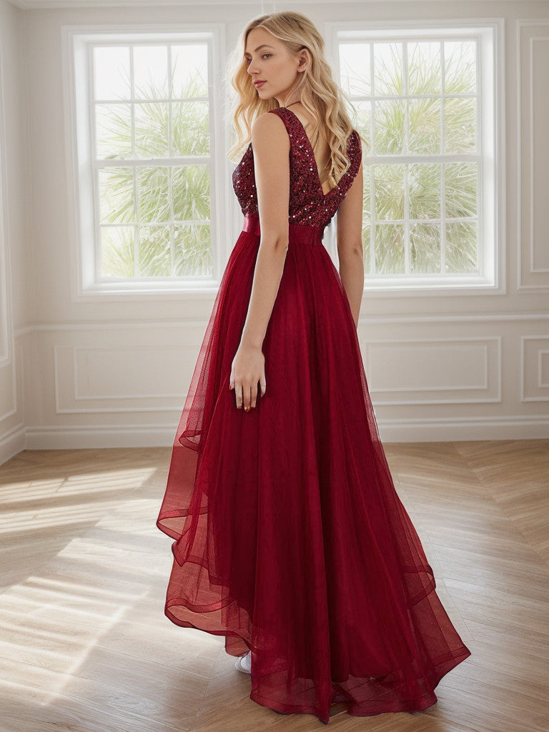 Back view of a sleeveless burgundy sequin tulle high-low evening gown.