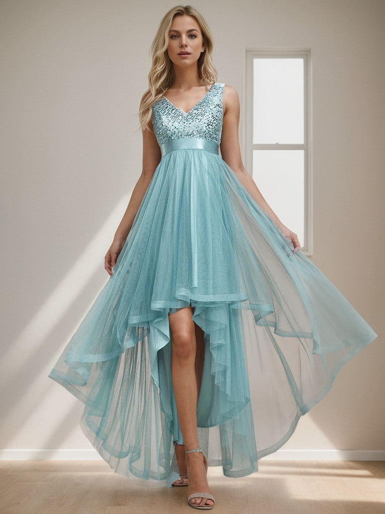 Woman wearing a sleeveless dusty blue sequin tulle high-low evening gown.