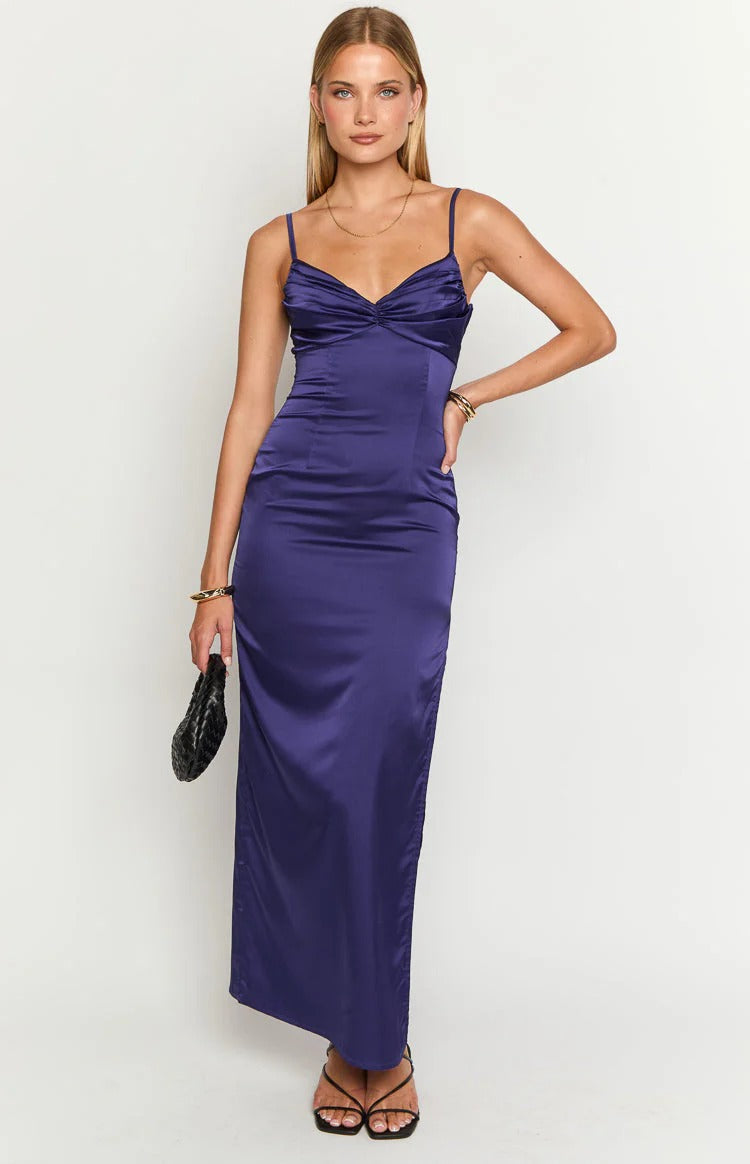 Woman posing in an elegant floor-length satin slip prom dress with a sweetheart neckline and spaghetti straps.