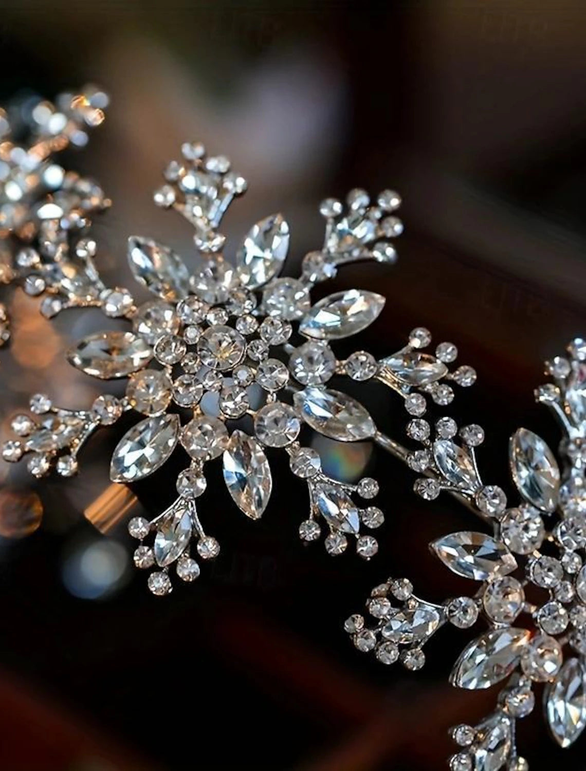Elegant snowflake headband with intricate crystal details, viewed from the front.