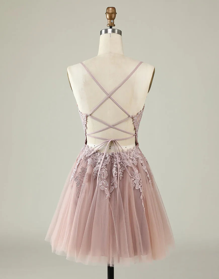 Back view of the tulle mini dress, highlighting the corset lacing and appliques.