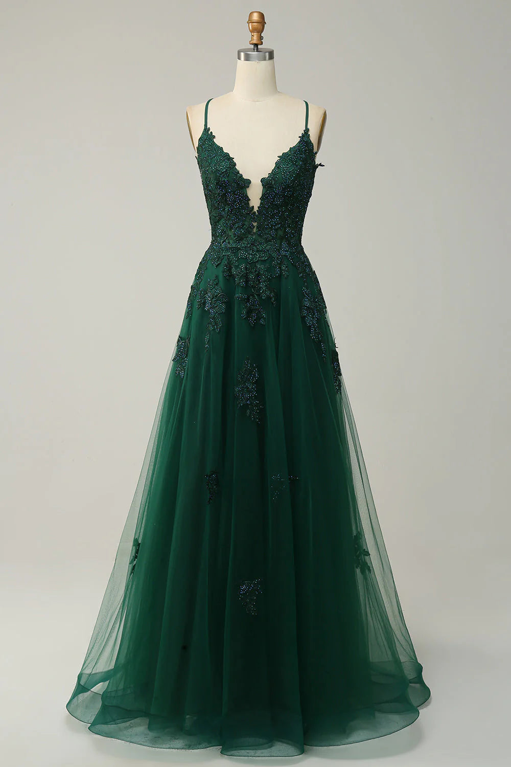 Full view of an elegant long prom dress with spaghetti straps, lace-up back, and delicate appliques.