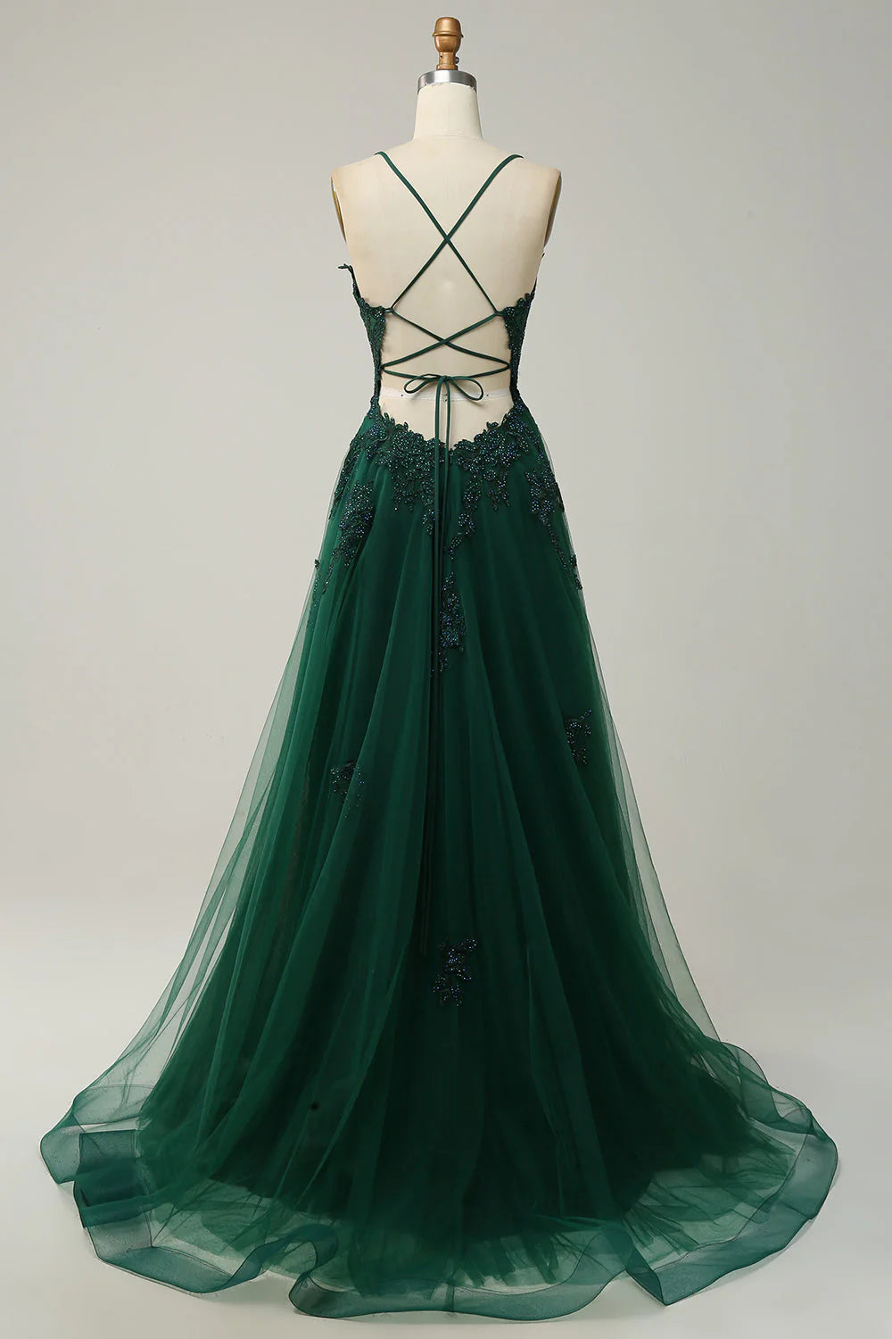 Close-up of the intricate lace-up back and floral appliques on the long formal dress.