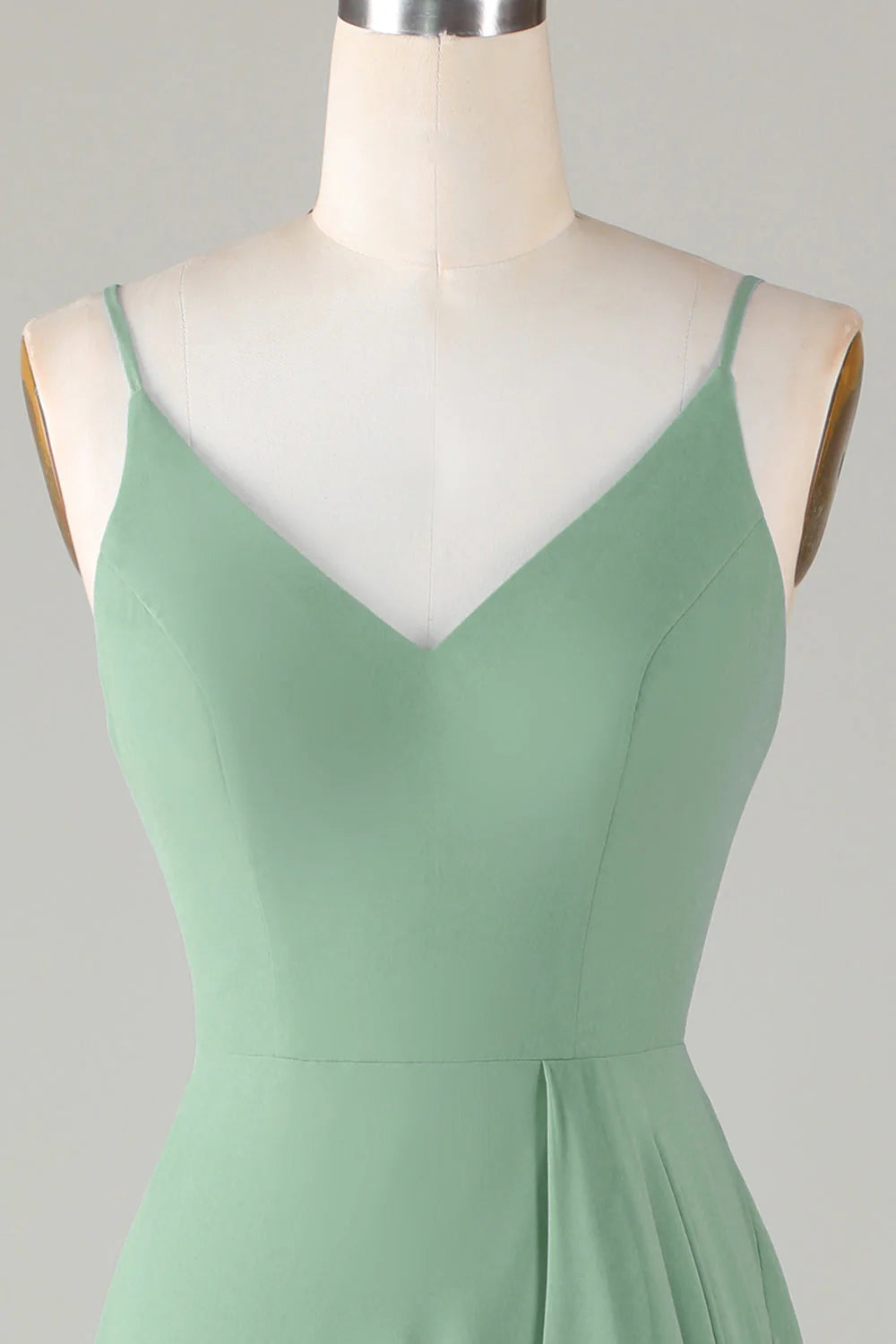 Close-up of the bodice and spaghetti straps of a formal dress.